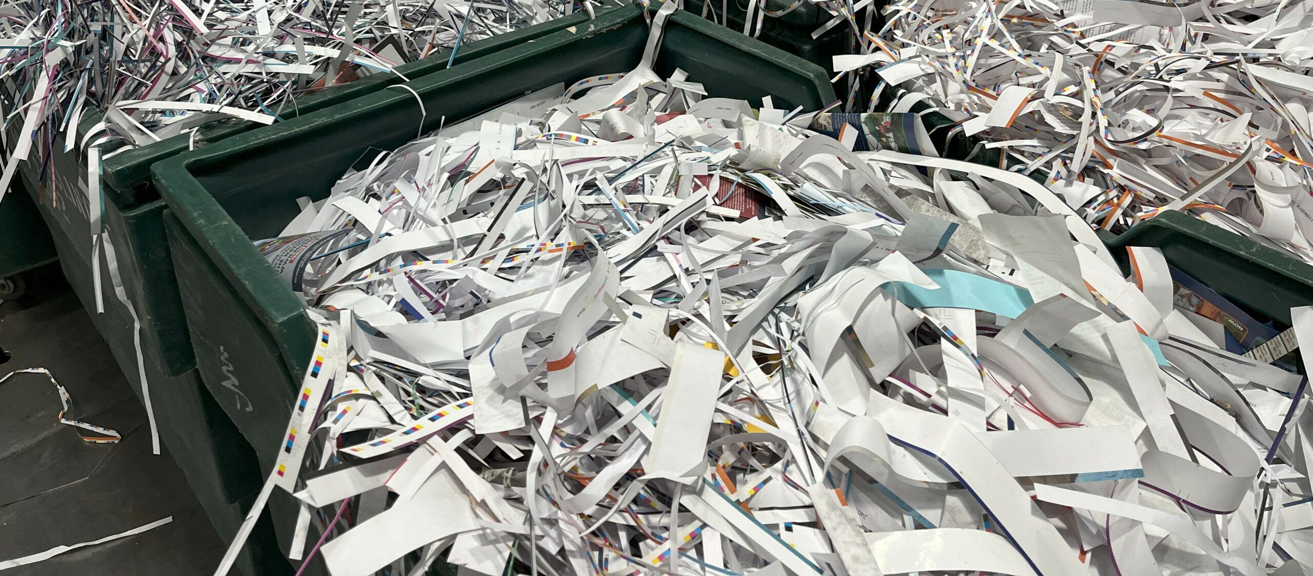 Dumpster bins full of shredded paper